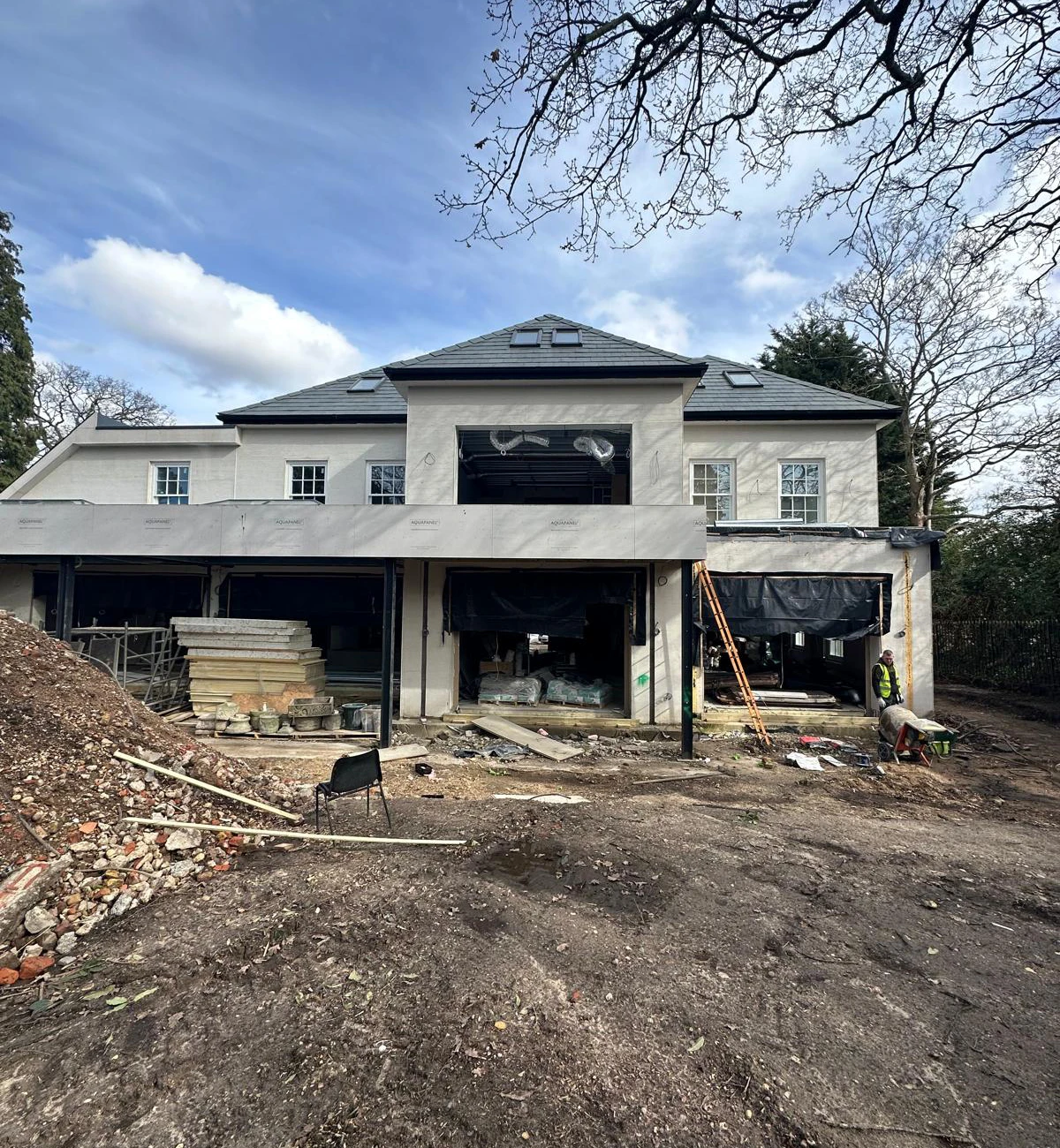 Plastering team working around house in London during exterior rendering and facade preparation